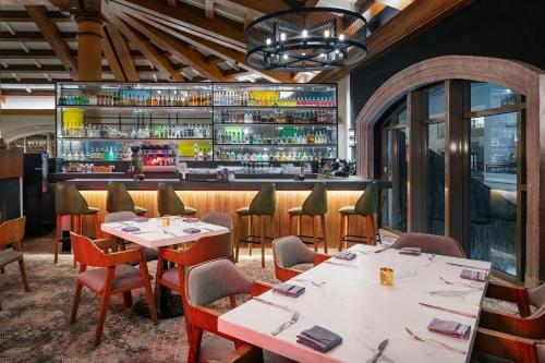 a restaurant with tables and chairs and a bar at JW Marriott Cancun Resort & Spa in Cancún