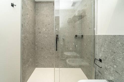 a bathroom with a glass shower with a toilet at Apt 2 min from the Cathedral with private parking in Como