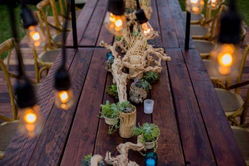 a wooden table with potted plants and lights on it at JW Marriott Cancun Resort & Spa in Cancún