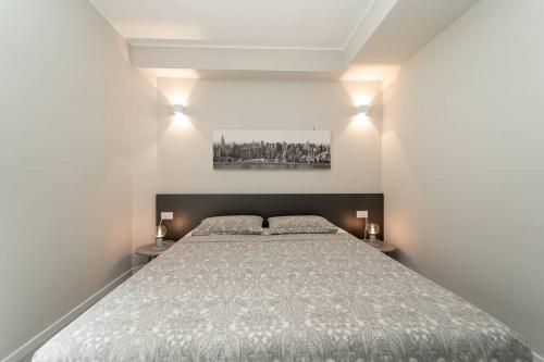 a bedroom with a large bed and two night stands at Apt 2 min from the Cathedral with private parking in Como