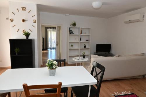 a living room with a white table and a couch at Sweet Home in Capua