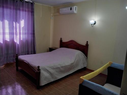 a bedroom with a bed and a couch at villa de charme in Grand Baie