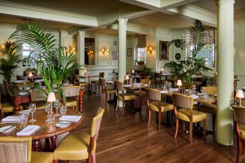 a restaurant with tables and chairs and plants at Hotel du Vin Bristol in Bristol