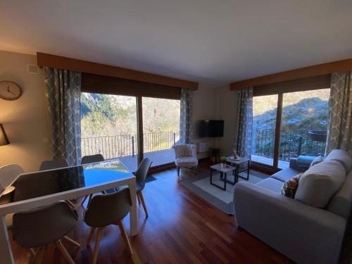 a living room with a couch and a table at La Mola de Prats Canillo HUT - 8338 in Meritxell