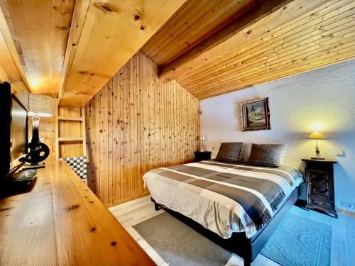a bedroom with a bed and a wooden ceiling at Chalet Val-d'Isère, 3 pièces, 4 personnes - FR-1-518-101 in Val-d'Isère