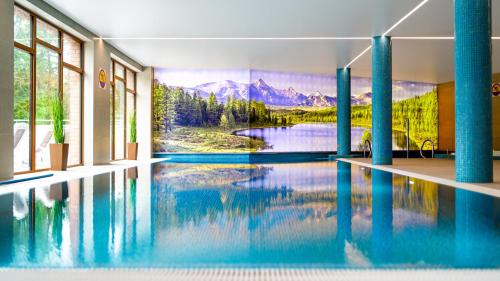 a swimming pool with a mountain mural on the wall at Apartamenty Good Time- Stone Hill II in Szklarska Poręba