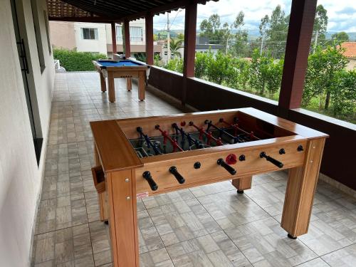 a wooden game table with wine bottles in it at Pousada Viver Capitólio in Capitólio