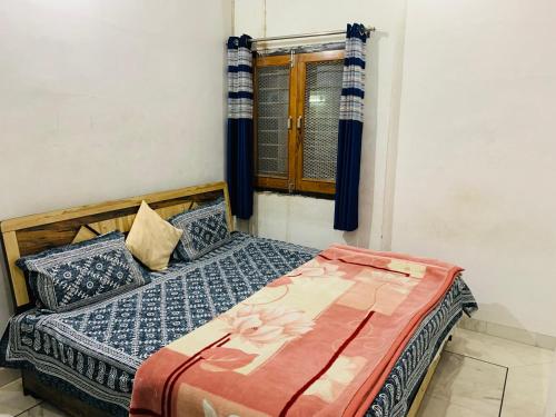 a bed in a room with a window at Udaipur Stays 2 in Udaipur