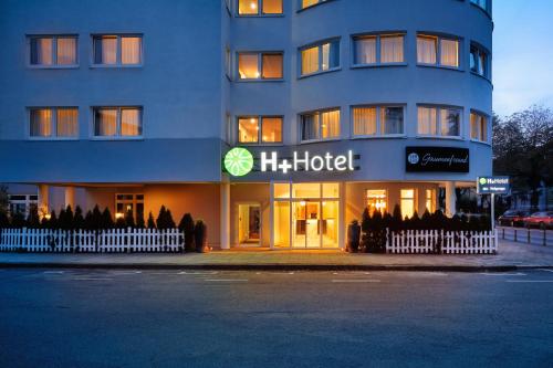 a hotel building with a hotel sign in front of it at H+ Hotel Darmstadt in Darmstadt