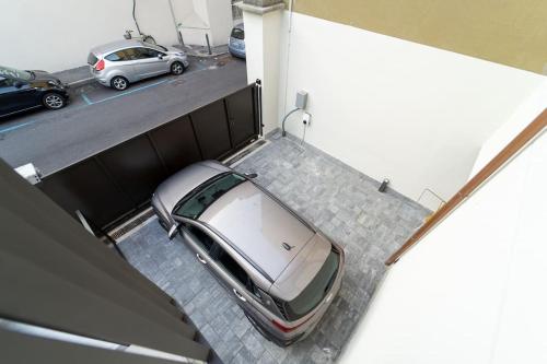 a car is parked in a parking lot at Appartamento moderno a 2 minuti dal duomo di Como in Como