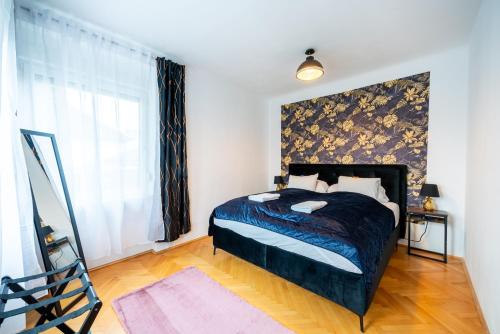 a bedroom with a bed and a large window at Modernes Appartement in Graz