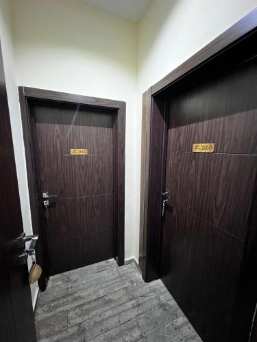 two wooden doors in a room with a hallway at Fragrance Apartments and Suites in Ibadan