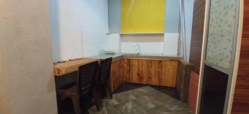 a kitchen with a sink and a wooden table at Yak City Apartments in Kandy