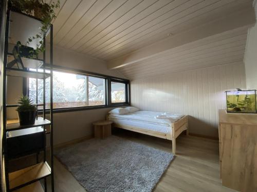 a small room with a bed and a window at Newly renovated apartment with a central location in Geilo