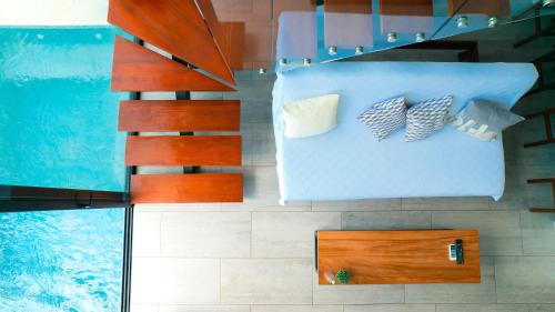 an overhead view of a bedroom with a swimming pool at Tropical Loft Home - Ocean View in San Juan del Sur