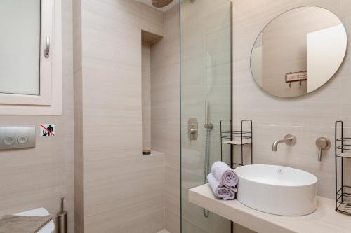 a bathroom with a sink and a shower at SeaView Apartment 1 in Samos