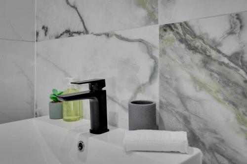 a bathroom with a sink and a faucet at CityView Executive Apartments Southend in Southend-on-Sea