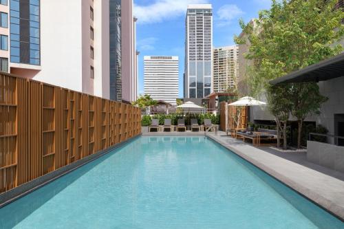 a swimming pool in the middle of a city at Courtyard by Marriott Bangkok Sukhumvit 20 in Bangkok