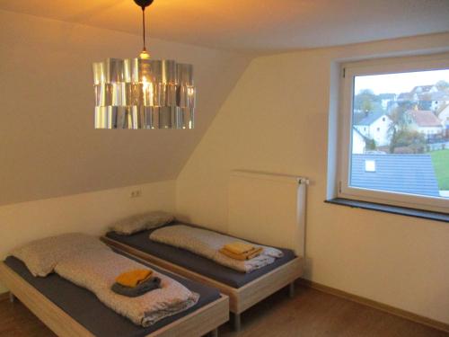 a room with two beds and a window at Parsberger Ferienwohnung 6 in Parsberg