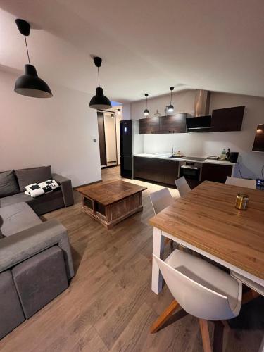 a living room with a couch and a table at Apartamenty na Maja - 6 in Skierniewice