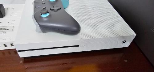a video game controller sitting on top of a box at Milan Condo ideal for Families,Pets,Business in Milan