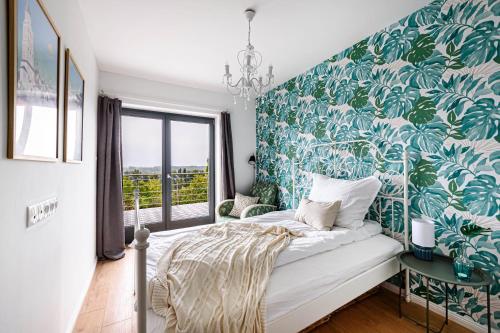 1 dormitorio con 1 cama con papel pintado verde y blanco en Dézsafürdős ház kilátással a Dunakanyarra en Kismaros