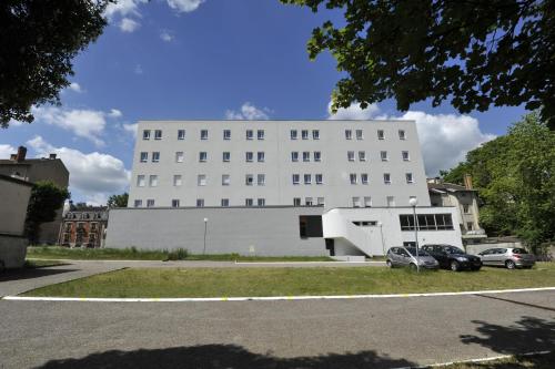 a white building with cars parked in front of it at Apparteo Nancy in Nancy