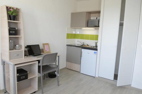 a small kitchen with a desk and a computer at Apparteo Nancy in Nancy