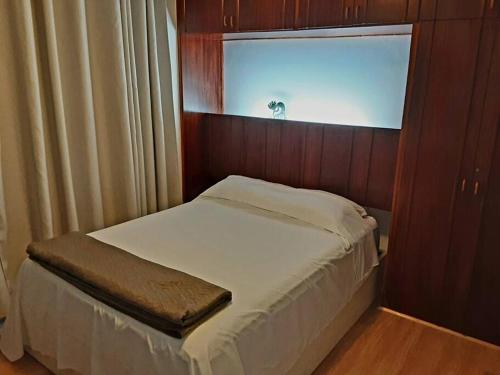 a small bed in a room with a window at Studio116-completo, confortável, amplo, prático in Brasilia