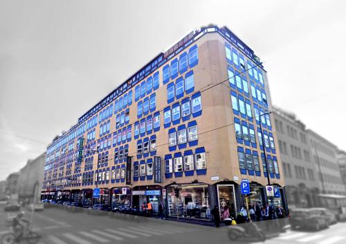 a large building with blue windows on a city street at Hotel Vitruvio in Milan