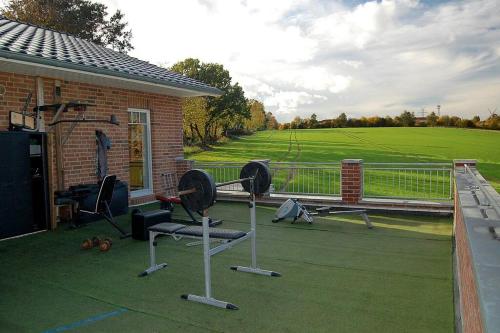 a house with some exercise equipment on a patio at Ferienhaus Seestern in Reinbek in Reinbek