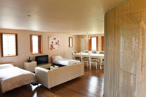 a living room with a bed and a dining room at Glenskirlie Castle Hotel in Banknock