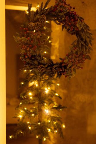 a glass vase with a christmas tree with lights at Dimore di Brando Vico Gelso in Polignano a Mare