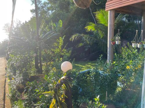 a garden with a street light in front of a house at COZY HOME PHU QUOC in Phu Quoc