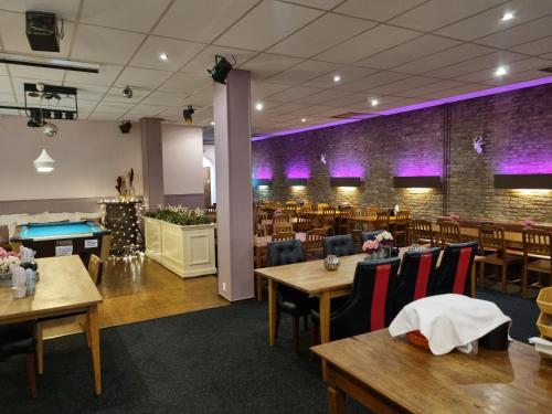 a dining room with tables and a pool table at Hotel Dupuis in Valkenburg