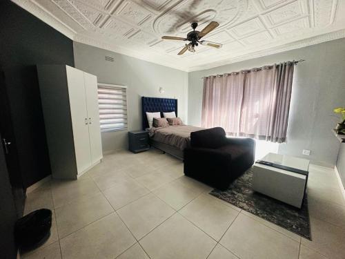 una camera con letto e ventilatore a soffitto di The Curve Apartments Unit 19 a Johannesburg