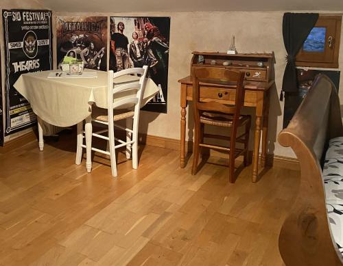 a dining room with a table and a desk at Chez Eric et Sophie in Tigné