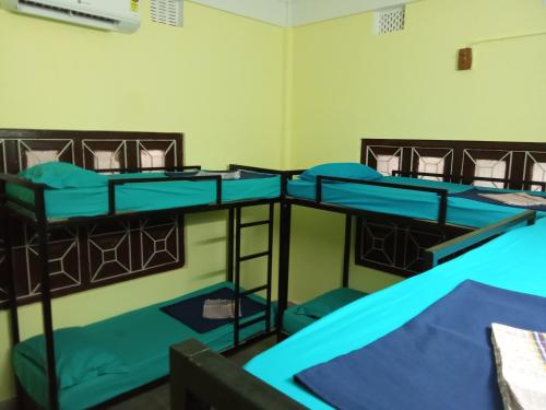 a group of three bunk beds in a room at Sili hostel in Siliguri