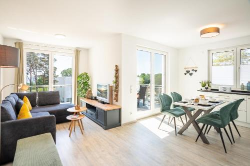a living room with a couch and a table at Apartment "Haffliebe" - Haffresidenz in Garz