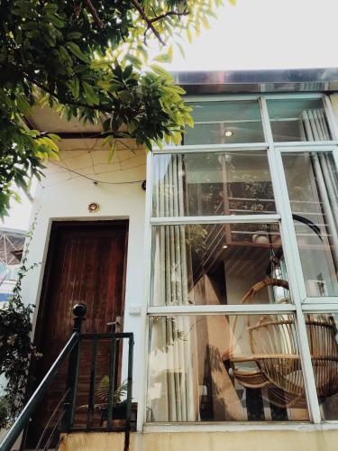 a front door of a house with a window at Azalea Apartment in Hanoi