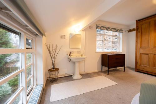 a bathroom with a sink and a toilet and a window at GuestReady - Elegant home in Manchester in Manchester