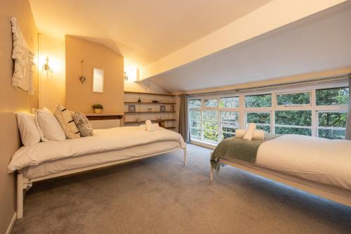 曼徹斯特的住宿－GuestReady - Elegant home in Manchester，一间卧室设有两张床和大窗户
