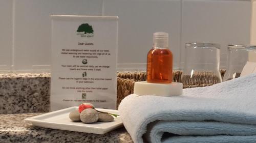 a bottle of soap next to a plate of towels at Meis Hotel in Bitez