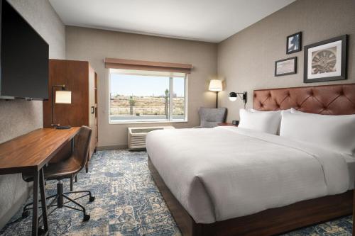 a hotel room with a bed and a desk at Four Points by Sheraton Yuma in Yuma