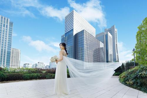 a woman in a wedding dress standing in front of a city at The Westin Yokohama in Yokohama