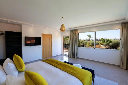 a bedroom with a large bed and a large window at Domaine K Marrakech in Marrakesh