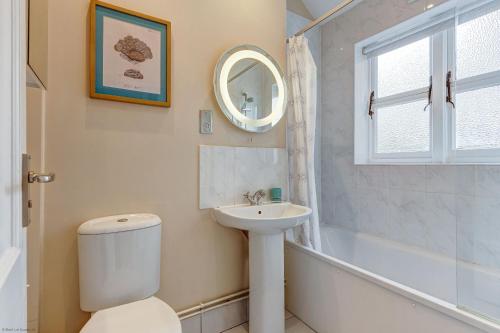 La salle de bains est pourvue de toilettes, d'un lavabo et d'un miroir. dans l'établissement Rawlinson Road 10A, à Oxford