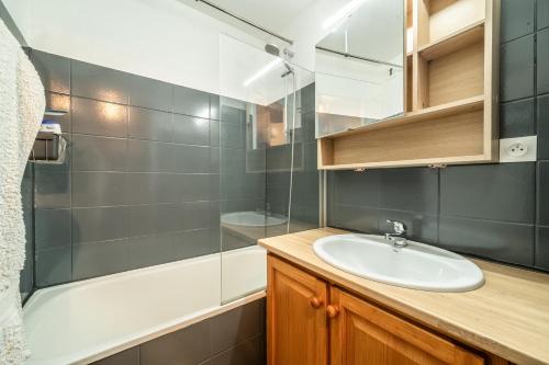 a bathroom with a sink and a shower at Appartement Morillon 4pers in Morillon