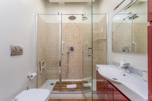 a bathroom with a shower and a sink at Rooftop 2 BDR Apartment with 360-Degree Views in Rome