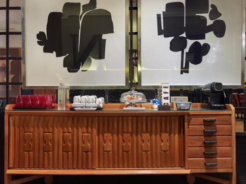 a counter in a restaurant with black and white posters at H10 Metropolitan 4* Sup in Barcelona